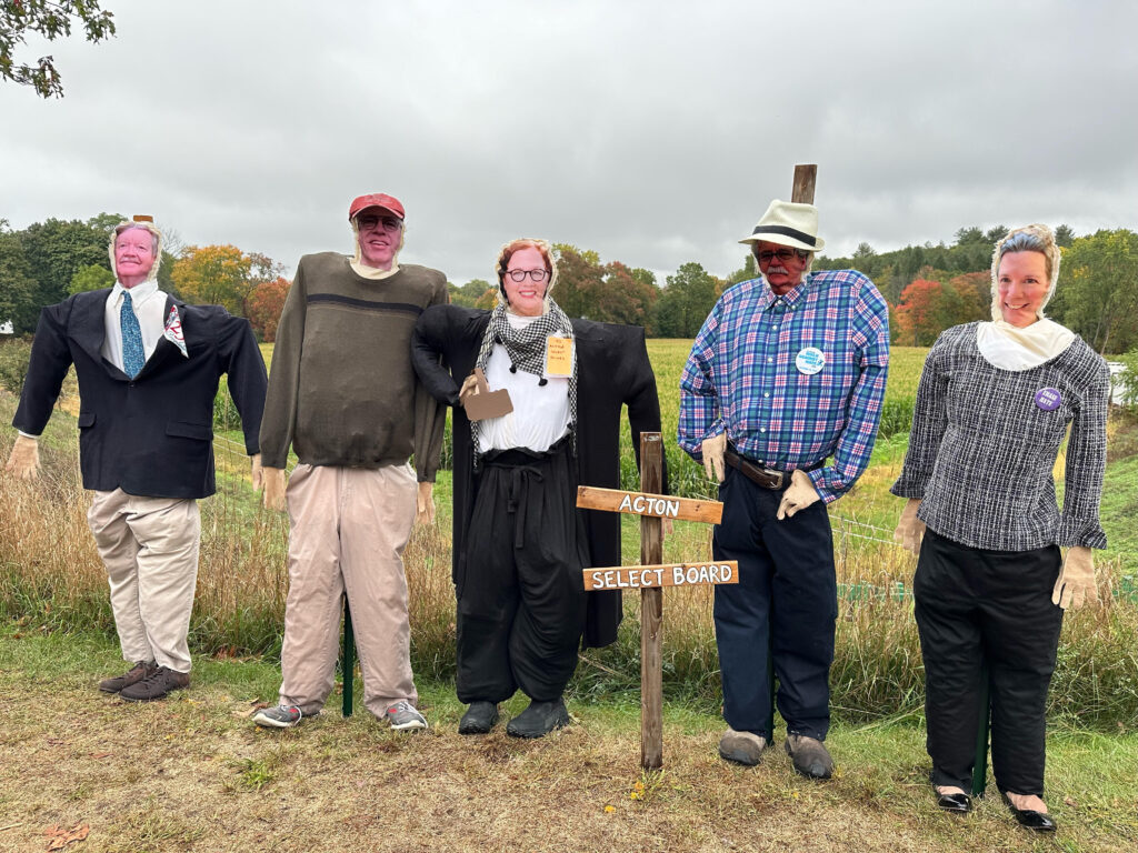 Select Board members, as scarecrows ,are appropriately clad:
* Dean Charter wears a blue sports jacket and a large Acton 250 sign.
* Jim Snyder-Grant sports a typical Jim sweater and baggyy chinos.
* Fran Arsenault wears a white shirt, long sweater, and a sporty scarf.
* David Martin wears a hat and a plaid button-down shirt.
* Alissa Nicol is fashionably clad in a plaid sweater and slacks.